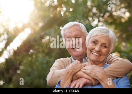 Content senior couple smiling happily outdoors together Stock Photo