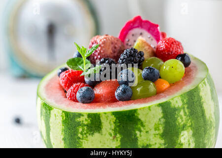 Tasty fruits salad in watermelon with berry fruits Stock Photo