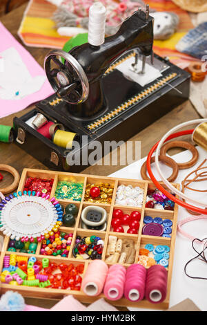 sewing machine and set of accessories to embroidery, haberdashery, sewing accessories top view, seamstress workplace, many object for needlework, hand Stock Photo