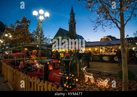 Children play in a small train at the traditional Christmas markets of Bolzano, in Italy. Stock Photo