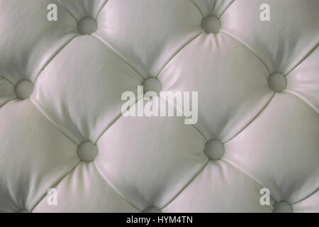 White buttoned leather texture. White leather background with button. Stock Photo