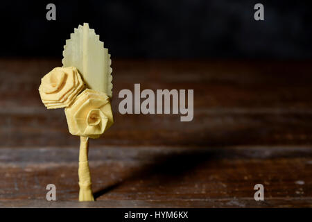 closeup of a small traditional spanish braided palm to be blessed on Palm Sunday on a rustic wooden surface Stock Photo