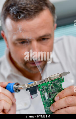 Soldering a video card Stock Photo