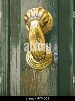 An old style decorative bronze door handles in the form of a woman's hand, the distinctive feature of Malta. Stock Photo