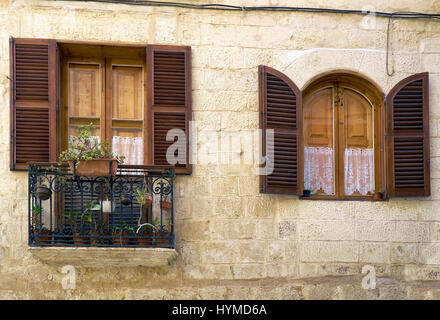 A traditional Maltese style window and open balcony on one of the residential houses of Valletta. Malta. Stock Photo