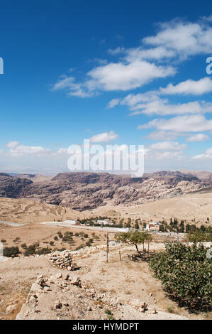 Jordanian landscape with mountains, vegetation and desert seen from the hills of Petra, the archaeological city famous for its rock-cut architecture Stock Photo