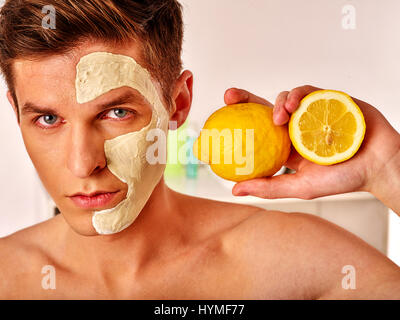 Facial man mask from fruits and clay . Face mud applied. Stock Photo