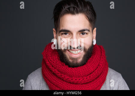 Close up portrait of a smiling man with beard and red scarf Stock Photo