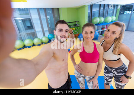 Group of sportive people in a gym taking selfie Stock Photo