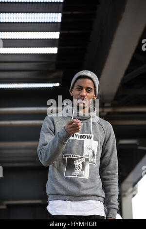 A candid portrait of a young man pointing at the camera in Brooklyn, NYC. Shot during the autumn of 2016. Stock Photo