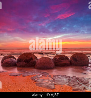 Moeraki Boulders, Otago, New Zealand - dramatic light at Moeraki Boulders, Otago, New Zealand. Stock Photo