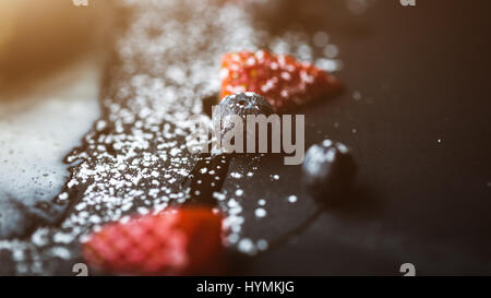 Macro photo of strawberry and Blueberries on slate plate with coconut background. Food concept. Red summer fruits. Close up object. Flare copy space for text, design Stock Photo