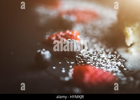 Macro photo of strawberry and Blueberries on slate plate with coconut background. Food concept. Red summer fruits. Close up object. Flare copy space for text, design Stock Photo