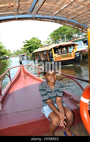 Kerala Shikara Boat Boy watching, Alleppey, Kuttanad Backwaters Lake. (Photo Copyright © by Saji Maramon) Stock Photo