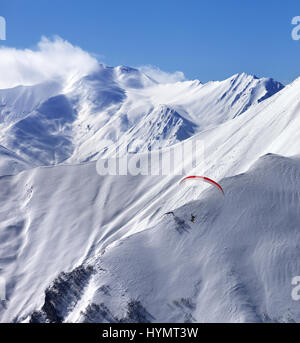 Speed flying in snow winter mountains at sun day. Caucasus Mountains. Georgia, region Gudauri. Stock Photo