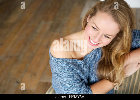 Close up portrait of a beautiful young woman relaxing and smiling at home Stock Photo