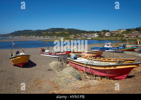 Colourful wooden fishing boats on the beach in the small coastal town of Curanipe in Maule, Chile Stock Photo