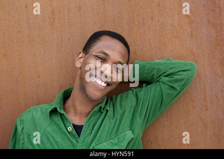 Close up portrait of a handsome young african american man relaxing outdoors Stock Photo
