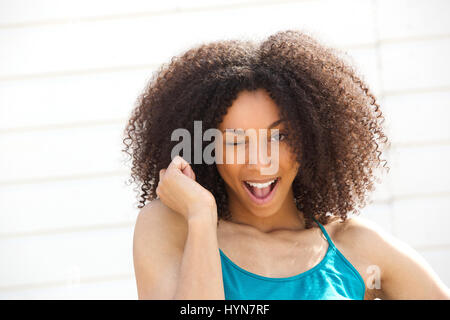 Close up portrait of a cute young woman winking eye smiling and flirting Stock Photo