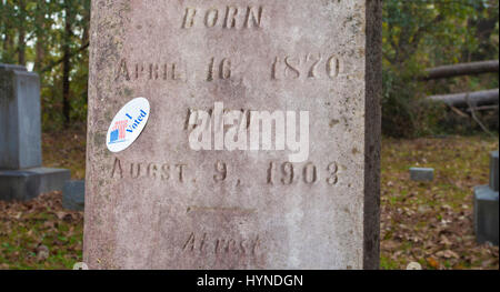 Grave marker with an I voted sticker on the tombstone Stock Photo