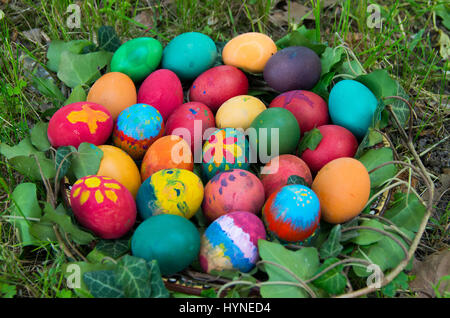 Hand painted Easter eggs hidden on the grass ready for the easter. Stock Photo