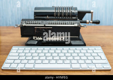 Modern keyboard and old adding machine Stock Photo