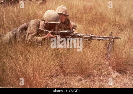 Men of the 1st Inf Div draw sniper fire while on a search and destroy mission. Bien Hoa, Vietnam, 10/65.. Stock Photo