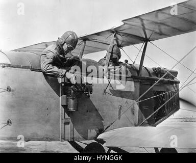 Photo shows a camera mounted on the side of a 1919 US Army plane. The first aerial cameras were modifications of existing plate cameras and were used for military reconnaissance and mapping during World War I. 1919. Stock Photo