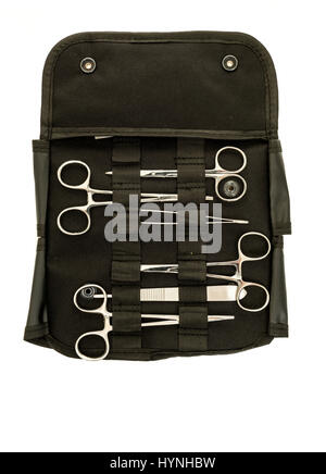 Surgical instrument kit on including hermostasts, scissors, holder, needle probe, and tweezers on an isolated background Stock Photo