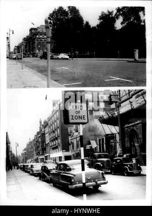 Jul. 10, 1958 - Opening Of The Mayfair Parking Meter Scheme: The Parking Meter Scheme in London's Mayfair, came in to operation this morning. Motorists park their care in the Parking Meter Zone have to pay sixpence for an hour's parking and a shilling for two hours. The parking bays measure 20ft by 7ft. 6ins. Photo shows This was how Londonders beat the Parking Meter Scheme this morning. The TOP picture shows the scene in Grosvenor Square, with hardly any cars by the Parking Meters - whilst in South Audley-street, only fifty yards away, there were plenty of cars parked each side of the road - Stock Photo