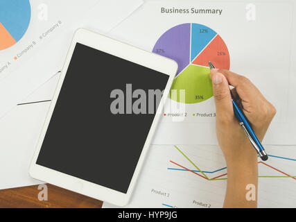 Working woman holding pen and teblet on bussiness report Stock Photo