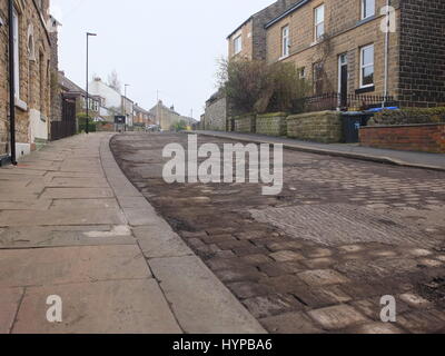 Ancient cobbles on the roadway are revealed prior to road resurfacing work on Walkley Crescent Road, Sheffield Stock Photo