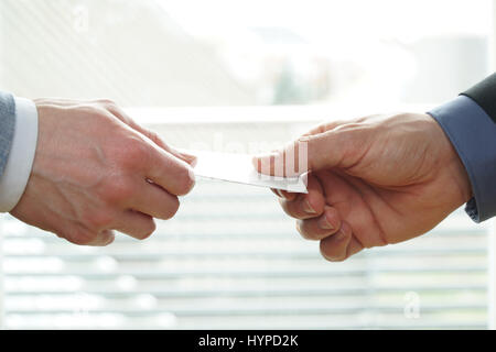 Young businesspeople exchanging Visiting Card In Office Stock Photo