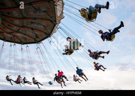 BARCELONA - SEP 5: People have fun at the carousel flying swing ride attraction at Tibidabo Amusement Park on September 5, 2015 in Barcelona, Spain. Stock Photo