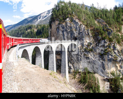 Filisur, Switzerland - April 27, 2016: The Landwasser Viaduct is a spectacular stone bridge, a 6 string. The construction on the three main pillars wa Stock Photo