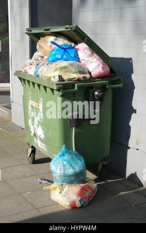 overflowing garbage container Stock Photo