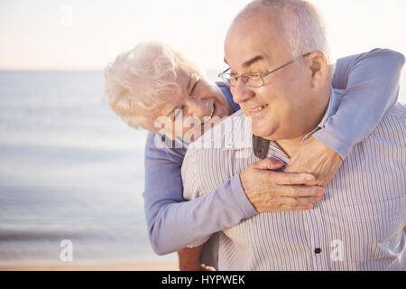 Man carrying wife on his back Stock Photo