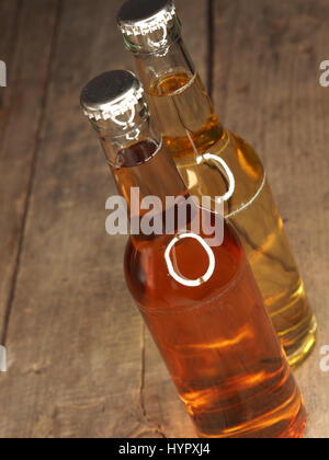 Two bottles of apple juice on an old rustic barn wood background Stock Photo