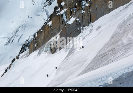 Chamonix, France - December 30, 2016: Climbers ascending final stretch on ridge leading up to Aiguille du Midi in early winter conditions Stock Photo