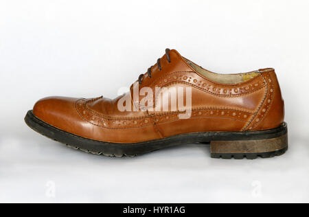 Men's used brown dress shoe isolated on white. Stock Photo
