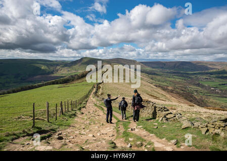 A family group walking the great ridge from Lose Hill to Mam Tor in the Peak District on a beautiful, sunny spring day. Stock Photo