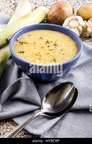 scottish leek and potato soup with thyme in a blue bowl Stock Photo