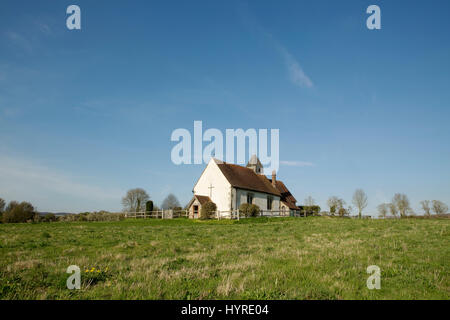 St Huberts church, the church in the field at Idsworth. Low angle shot with a clear blue sky. Stock Photo