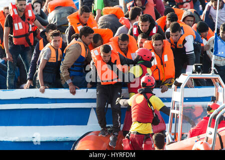 A 17 meter long wooden boat, found in the morning around 15 nautical miles away from the Libyan coast. 399 people, who are on board are trying to cros Stock Photo