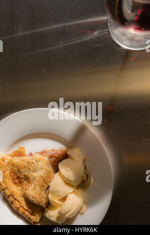 Wine glass leaves shadow across apple pie plate Stock Photo