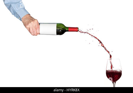 Wine pouring from bottle into glass Stock Photo