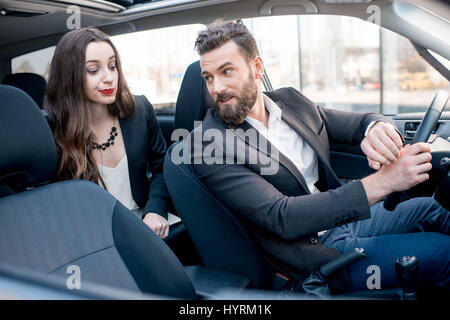 Business couple in the car Stock Photo