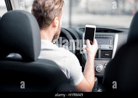 Man using phone in the car Stock Photo