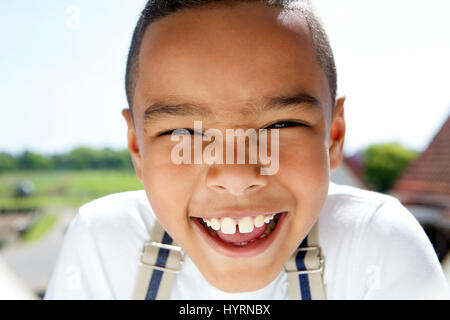 Close up portrait of a smiling little boy with suspenders Stock Photo