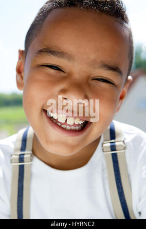 Close up portrait of a young boy smiling with suspenders Stock Photo